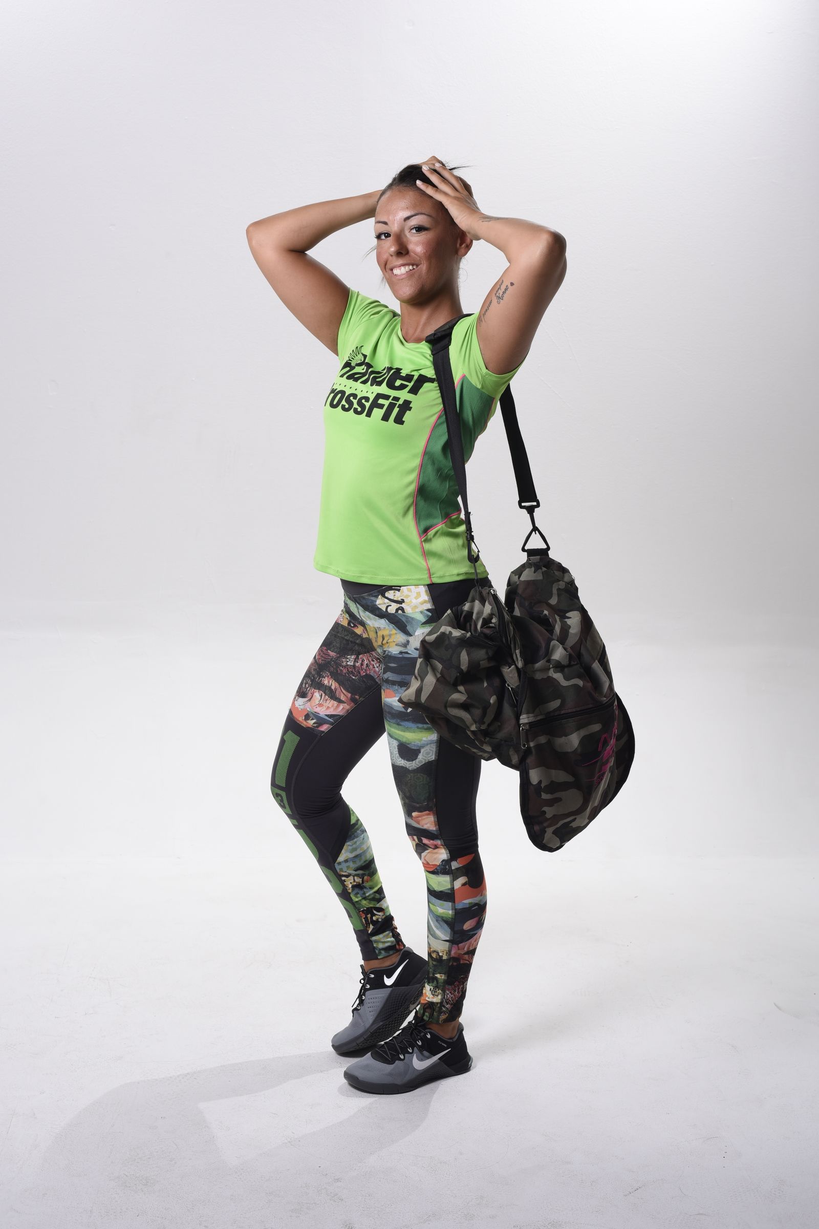 Woman in activewear holding a gym bag